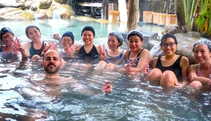 Retreat participants together in a hot spring pool