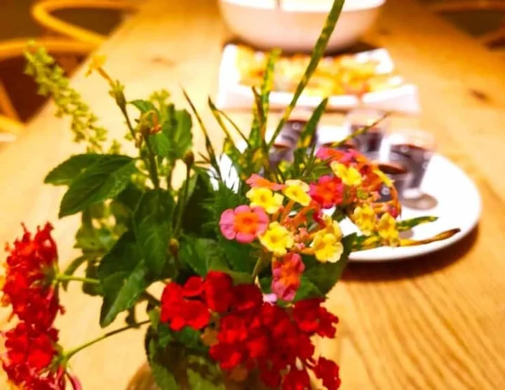 Fresh flowers in a vase beside a shared retreat meal